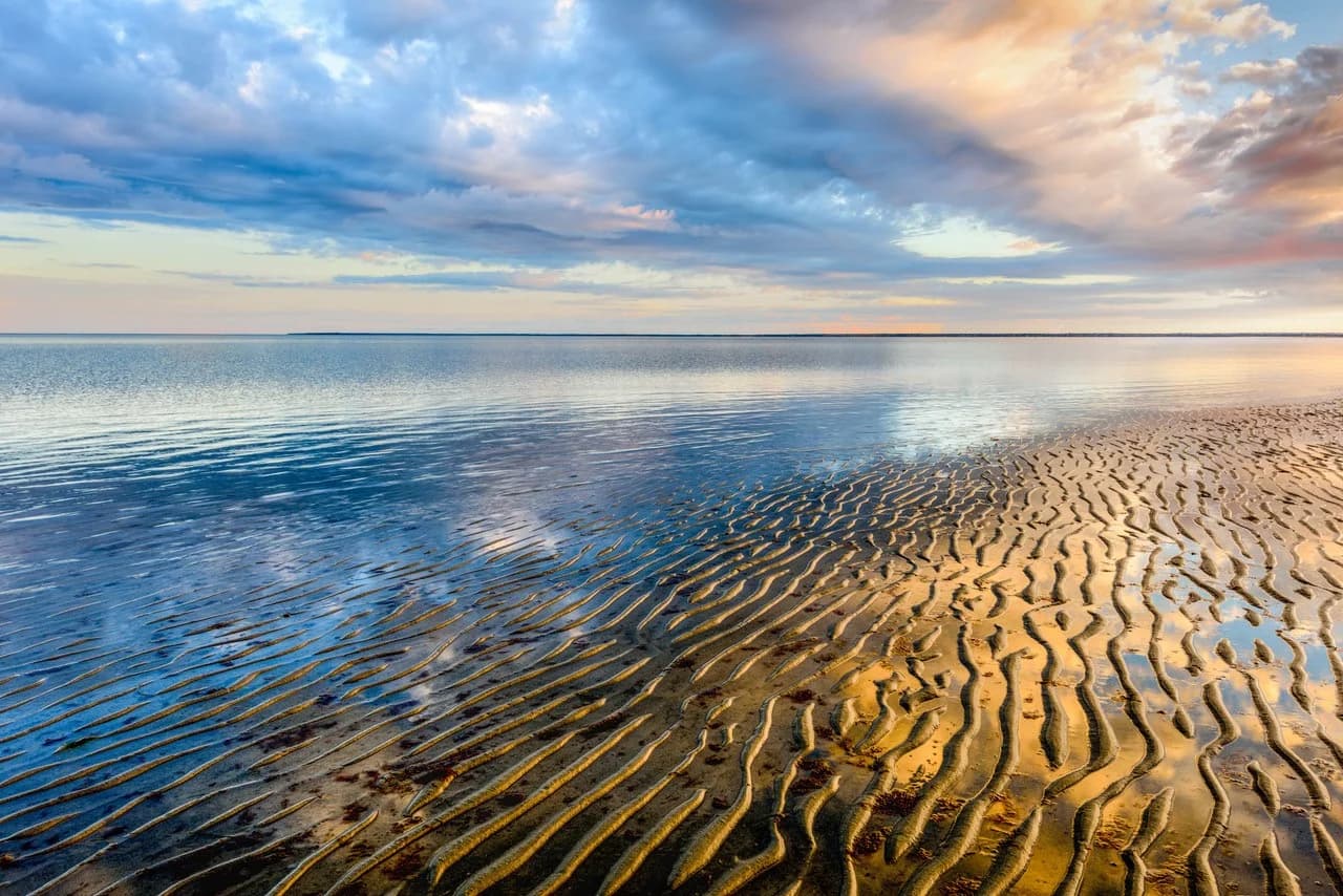 Rippled sand flats stretching toward Cape Cod Bay at low tide