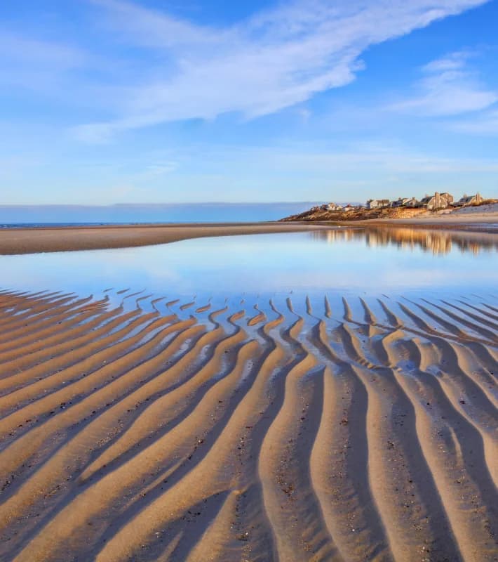 Wide tidal flats stretching across Mayflower Beach at low tide