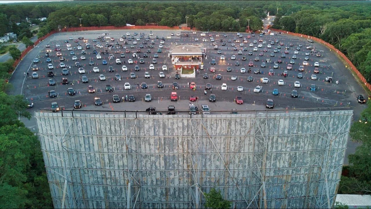 Aerial view of the Wellfleet Drive-In packed with cars on a summer evening